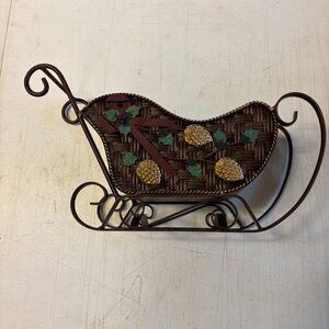 Santa’s sleigh tabletop decor. 16” long and 6” wide. 3-D RIBBON, HOLLY AND PINE